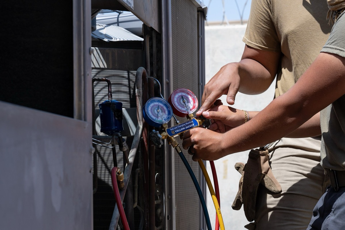 Manifold gauges connected to an air conditioning system during a service call