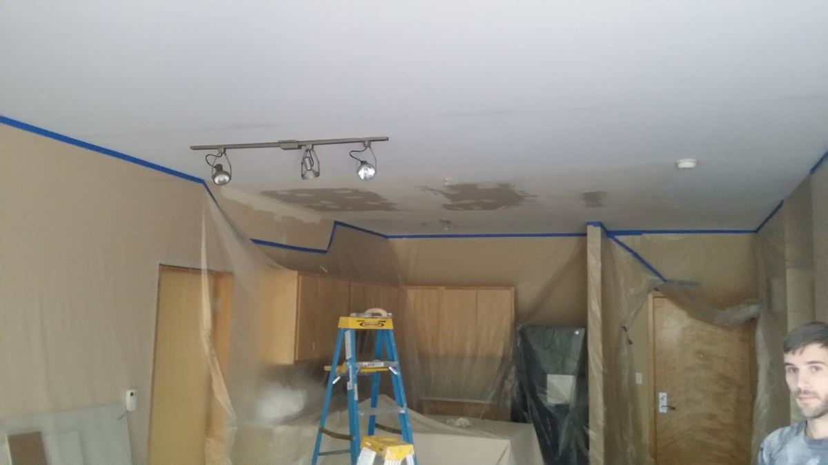 Interior room masked and prepared for drywall repair and painting